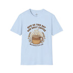 T-shirt featuring “Give Us This Day Our Daily Coffee”, coffee detail and bold lettering; calm strength.