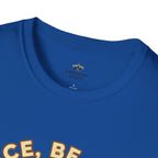 T-shirt featuring “Peace, Be Still”, sunrise detail and coffee detail and vintage lettering; enduring hope.