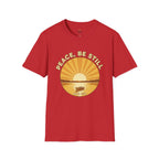 T-shirt featuring “Peace, Be Still”, sunrise detail and coffee detail and vintage lettering; grounded confidence.