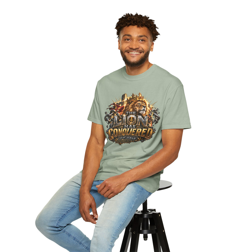 T-shirt featuring “Lion of Judah Conquered Graphic”, lion artwork and  and forged-style lettering; positive energy.