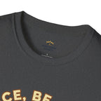T-shirt featuring “Peace, Be Still”, sunrise detail and coffee detail and vintage lettering; warm encouragement.