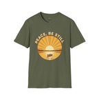 T-shirt featuring “Peace, Be Still”, sunrise detail and coffee detail and vintage lettering; hopeful spirit.